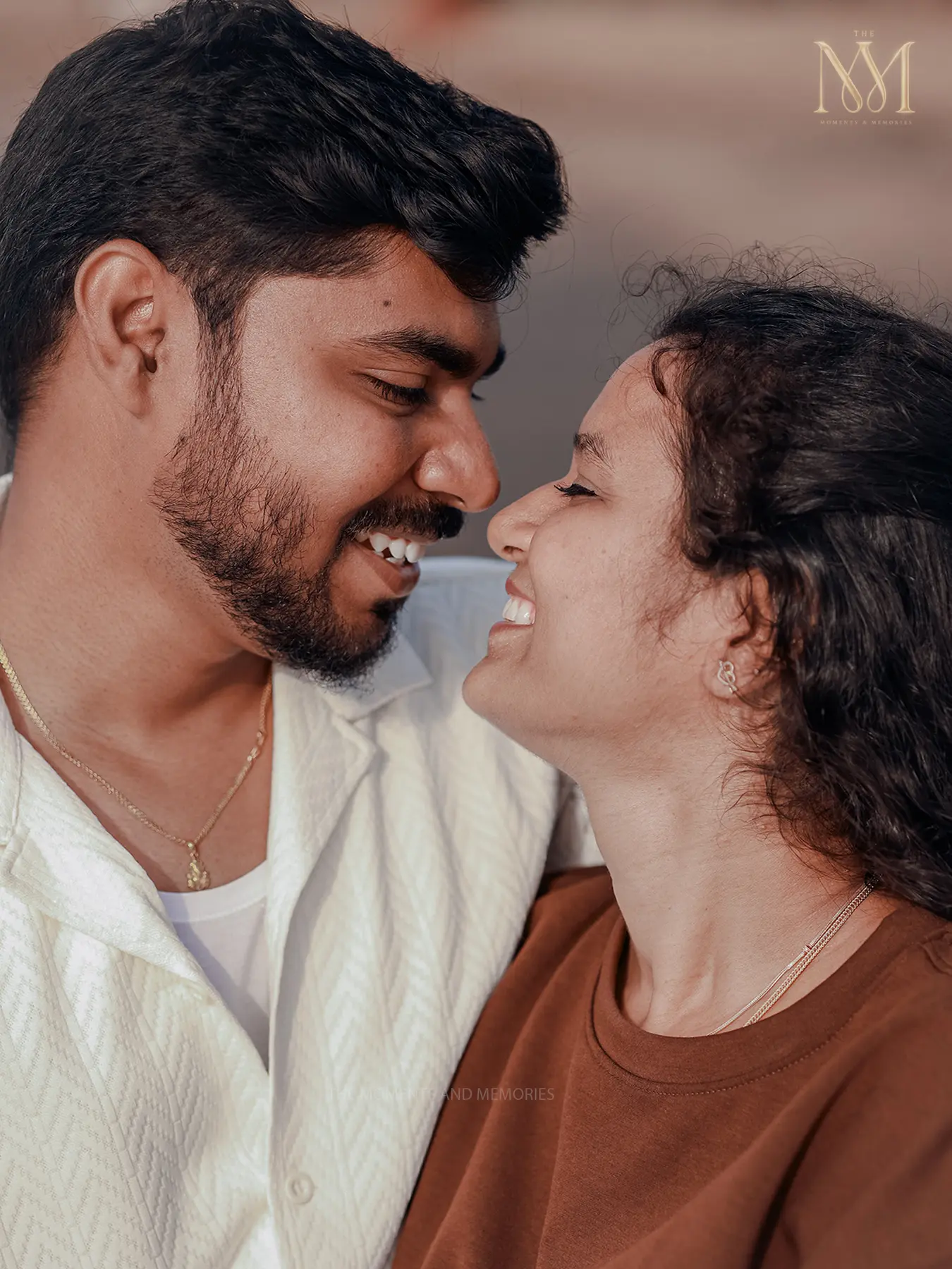 Close-up portrait of a couple smiling nose to nose